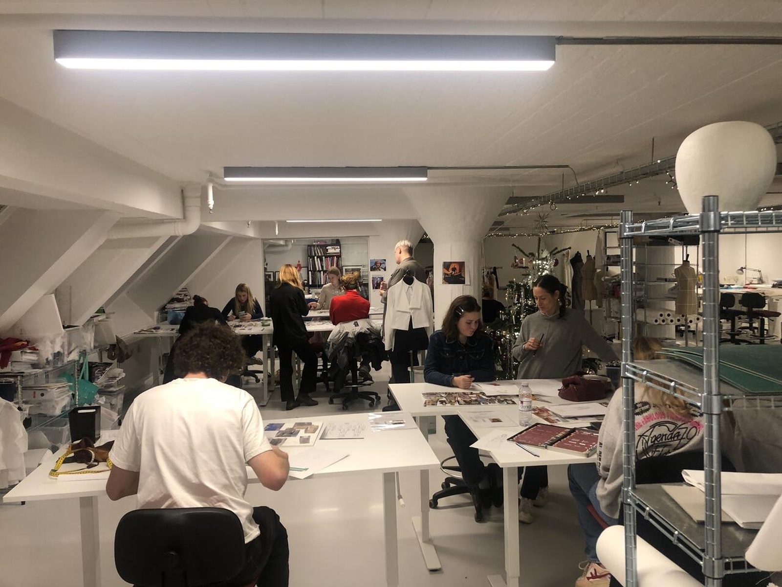 A studio of workbenches, mannequins and materials