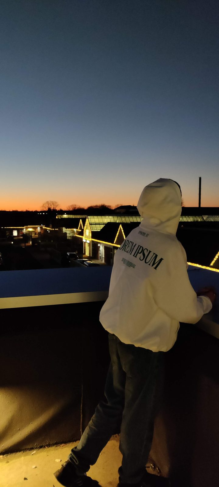 The white LOREM IPSUM hoodie at dusk